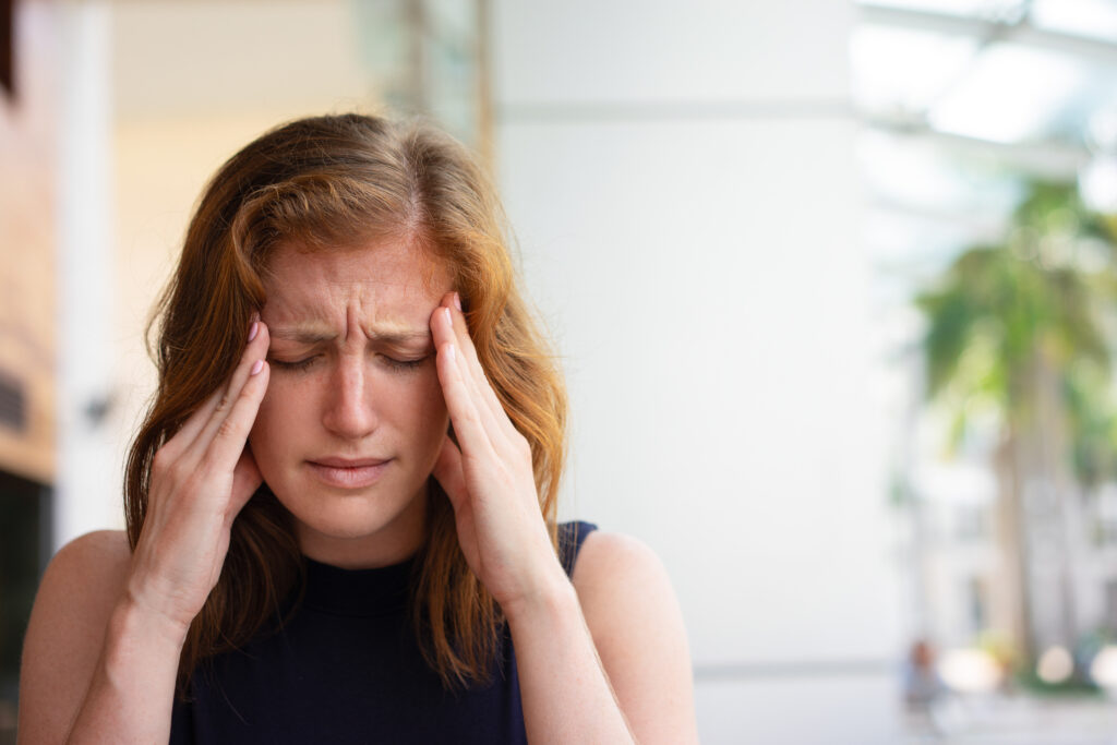exhausted office worker suffering from headache